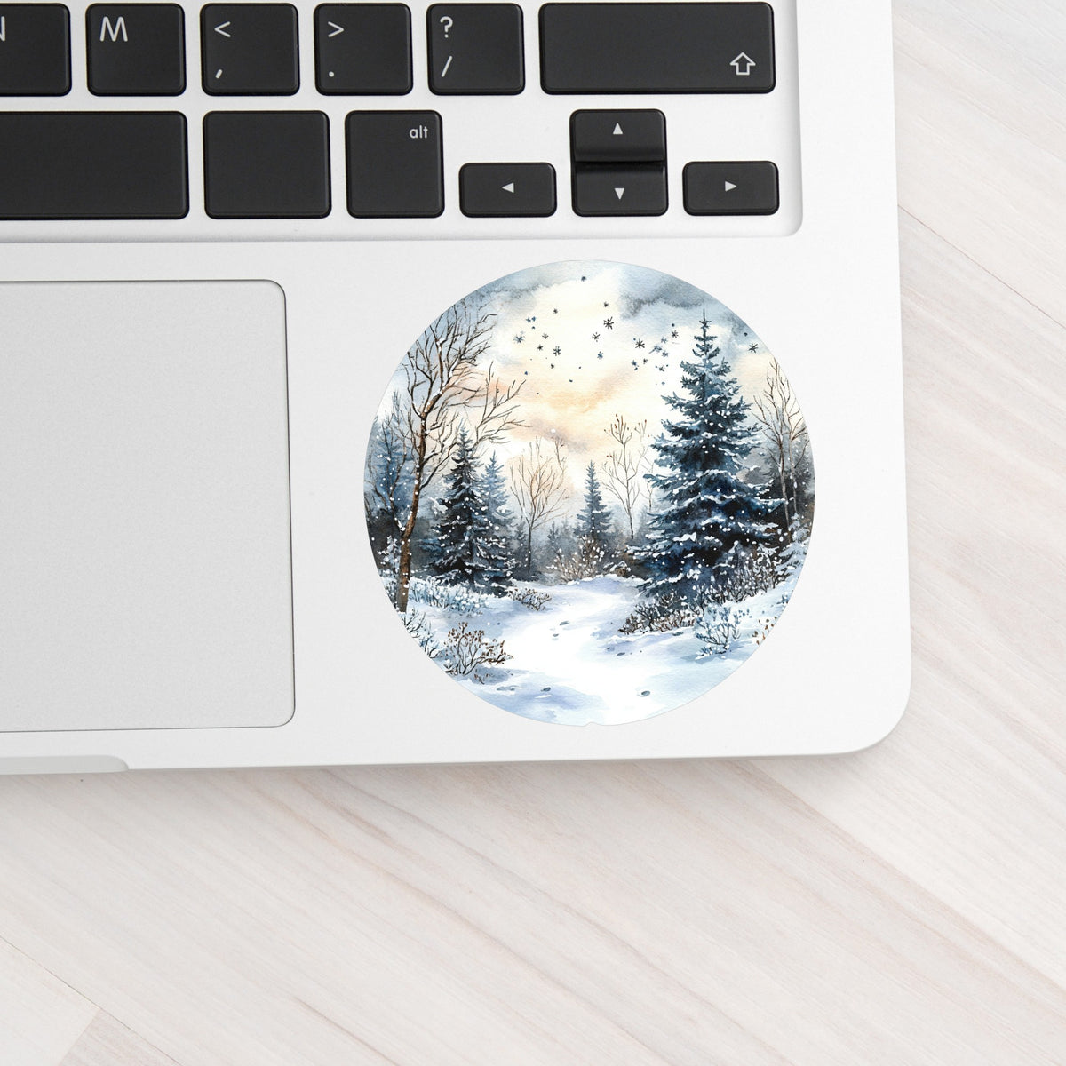 Starry Winter Night UV DTF sticker applied to a laptop beside the keyboard