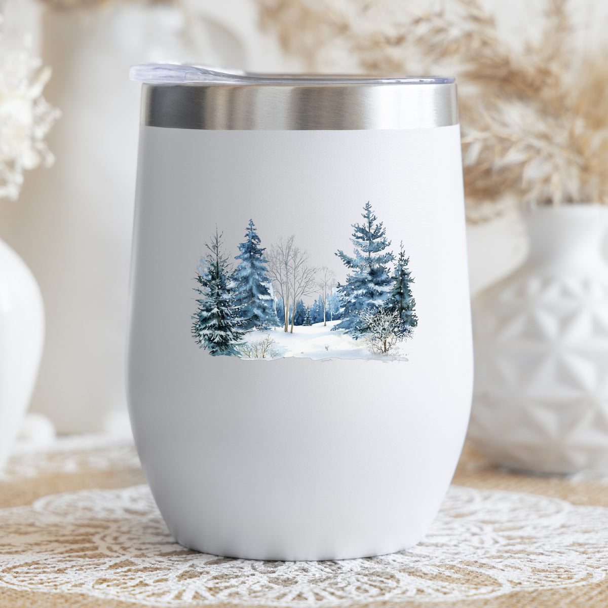 Blue Winter Pines And Birch UV DTF sticker applied to a stemless wine glass