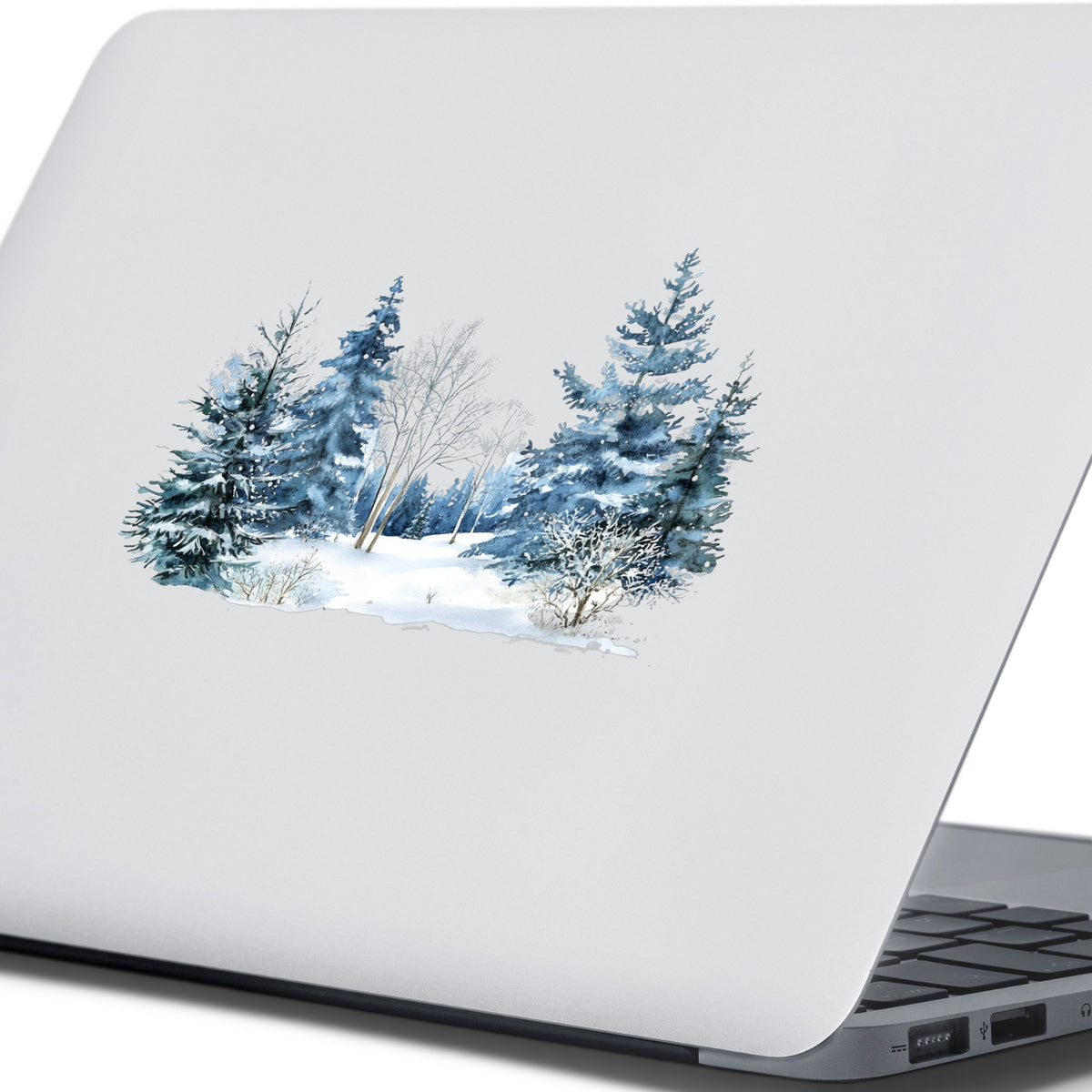 Blue Winter Pines And Birch UV DTF sticker applied to a laptop