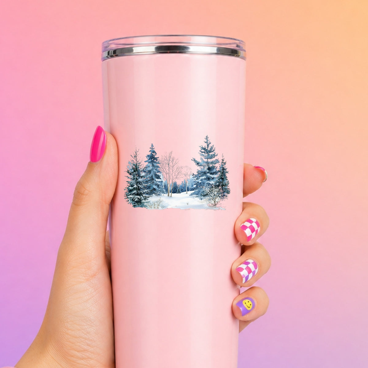 Blue Winter Pines And Birch UV DTF sticker applied to a pink tumbler