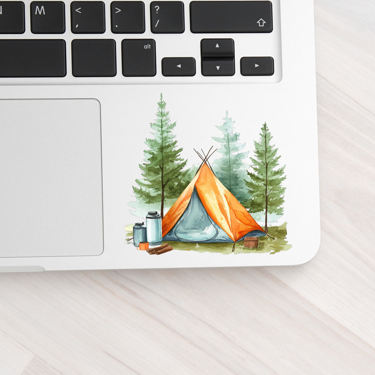 Orange Teepee Tent UV DTF sticker applied to a laptop beside the keyboard
