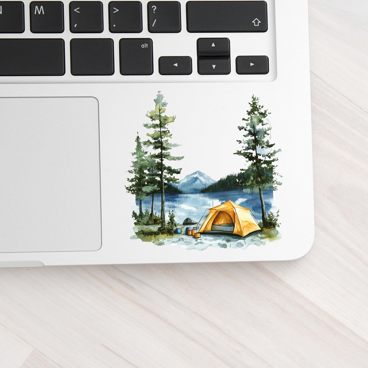 Yellow Tent By Lake UV DTF sticker applied to a laptop beside the keyboard