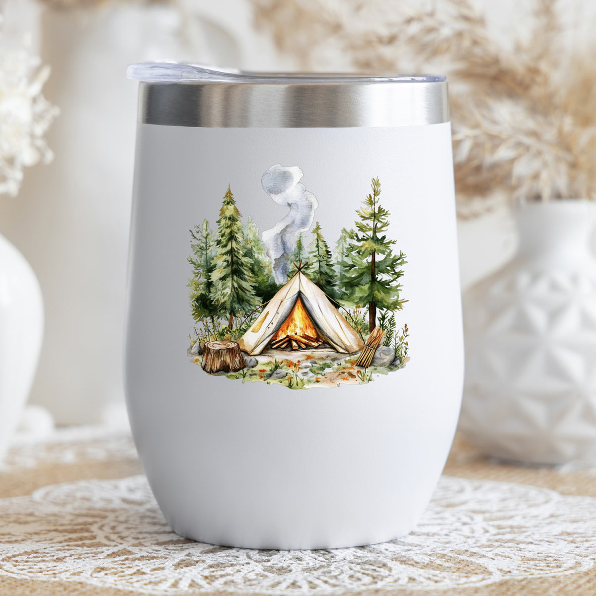 Canvas Teepee With Campfire UV DTF sticker applied to a stemless wine glass