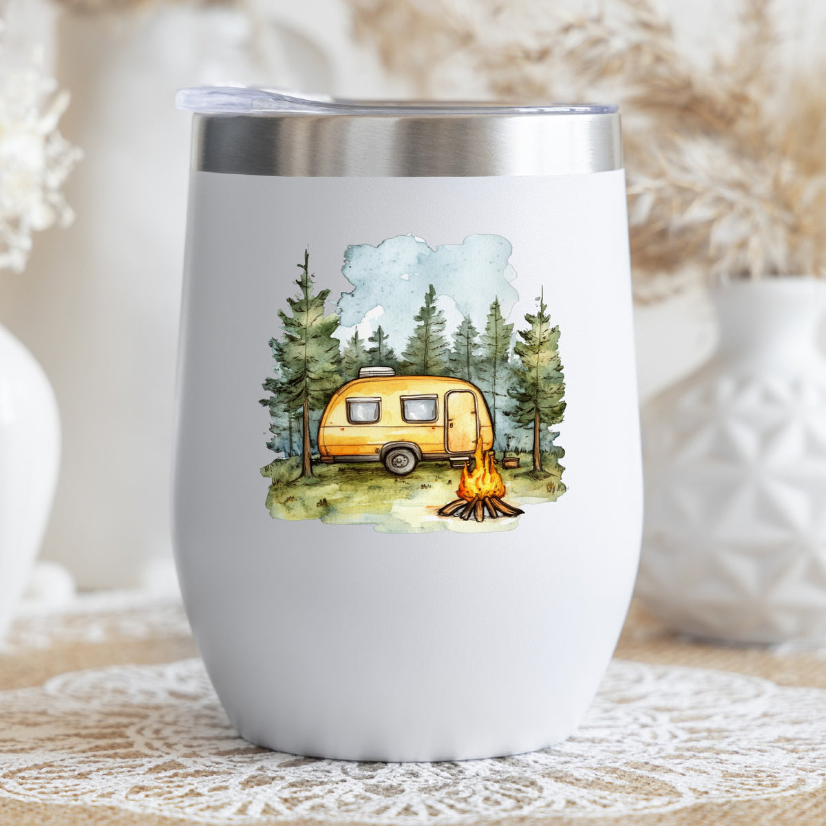 Yellow Camper Trailer UV DTF sticker applied to a stemless wine glass
