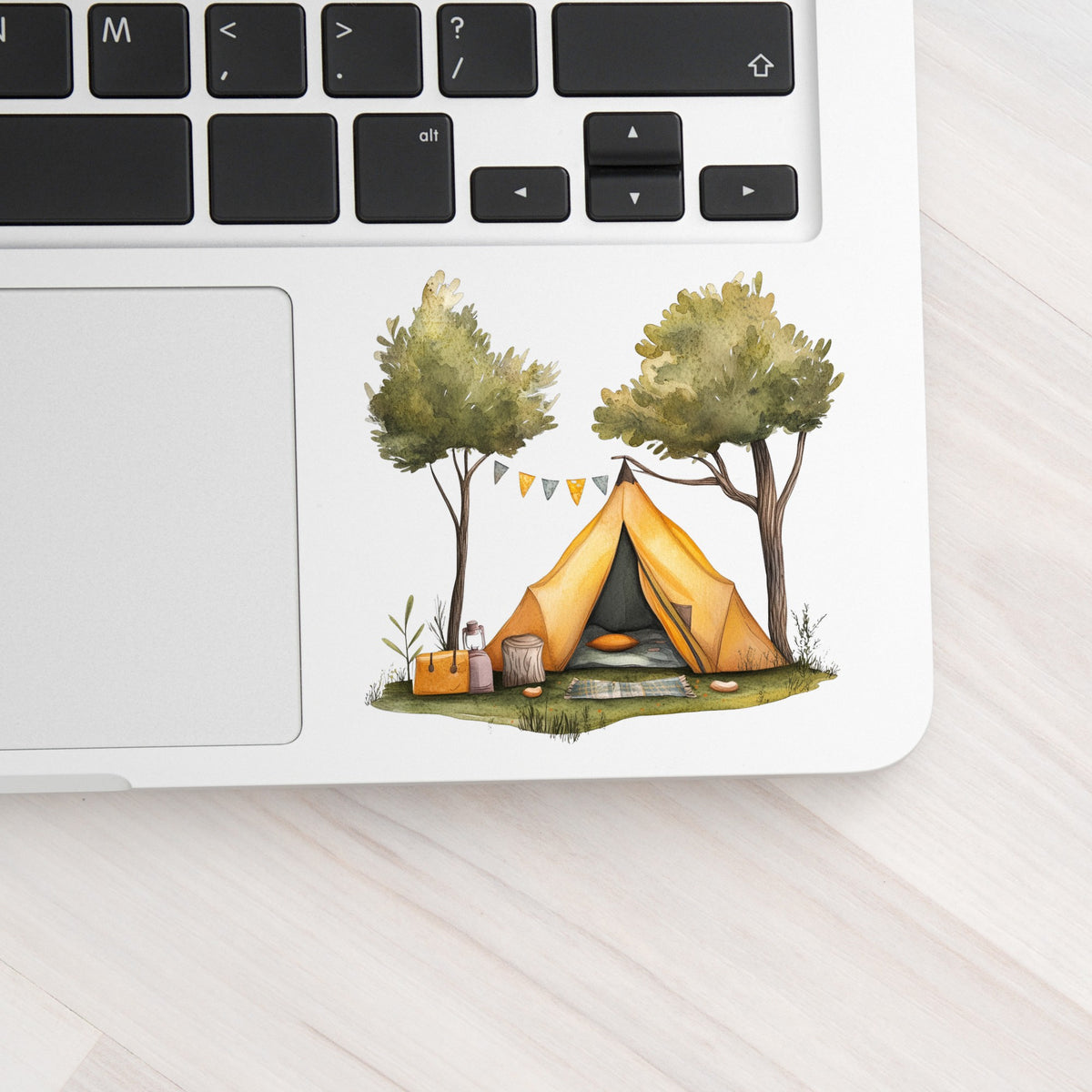 Bunting Flag Camp Tent UV DTF sticker applied to a laptop beside the keyboard