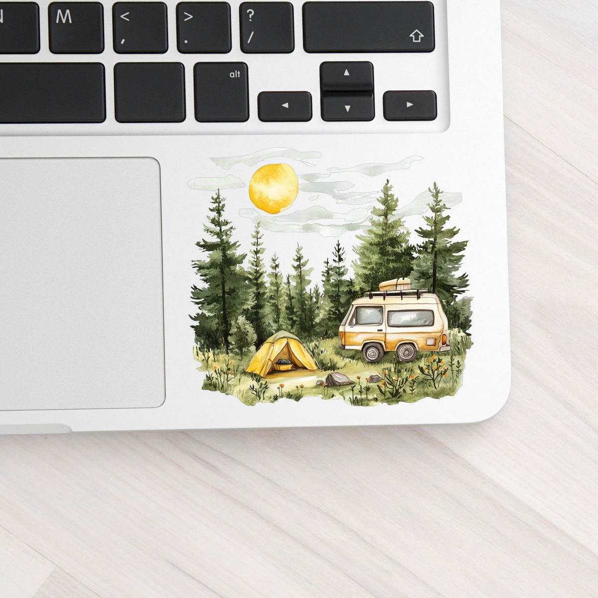 Camper Van And Tent UV DTF sticker applied to a laptop beside the keyboard