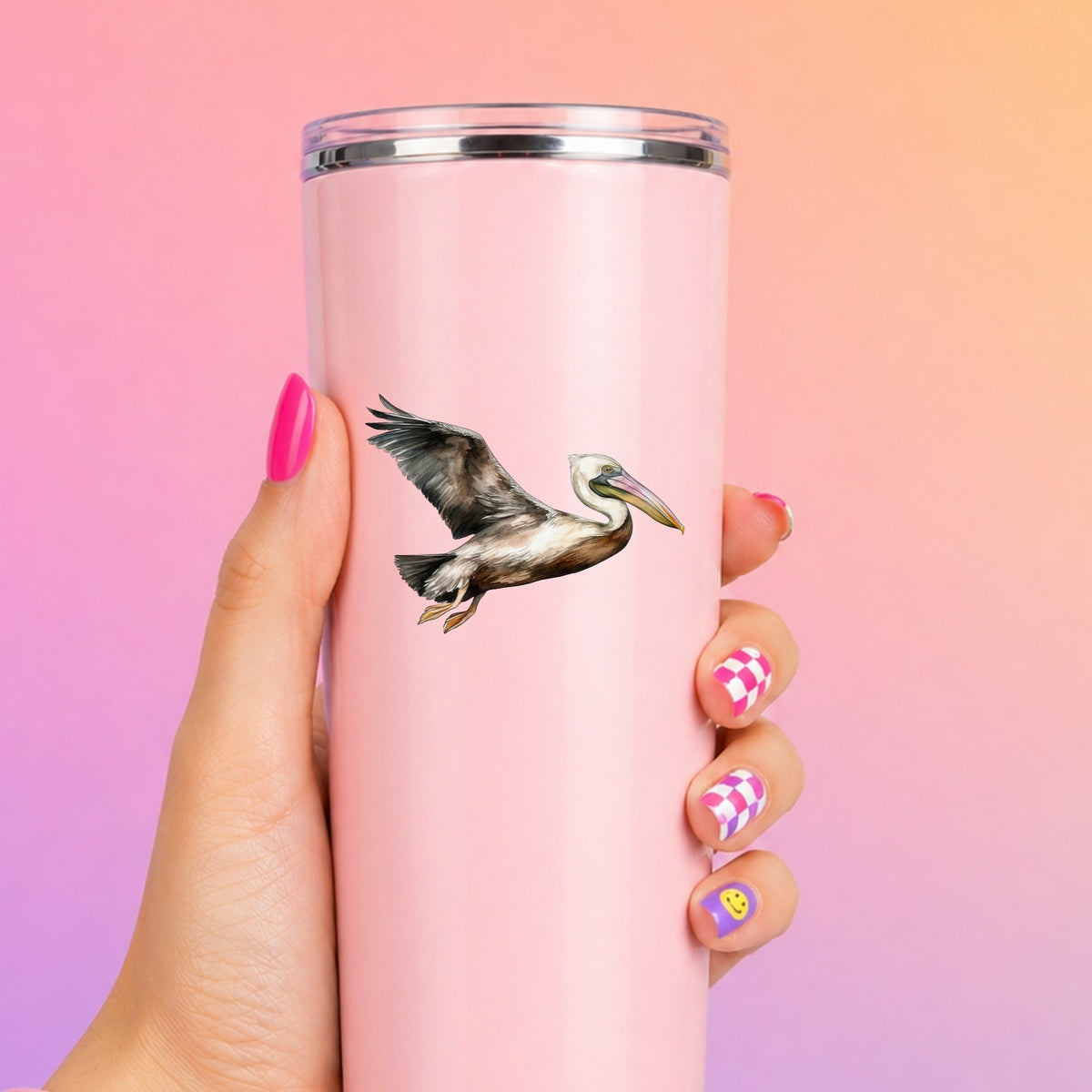 Flying Brown Pelican UV DTF sticker applied to a pink tumbler