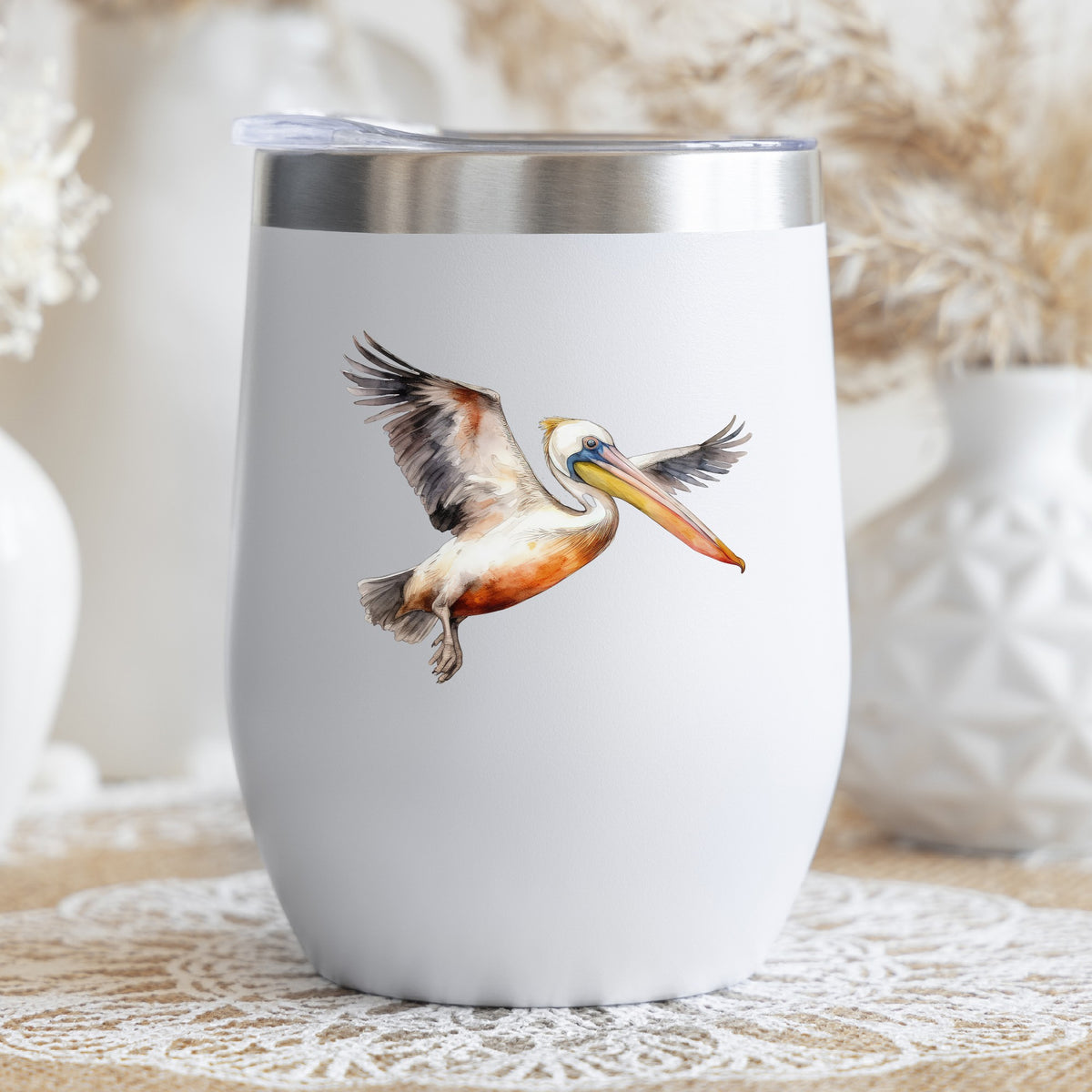 Pelican With Wings Spread UV DTF sticker applied to a stemless wine glass