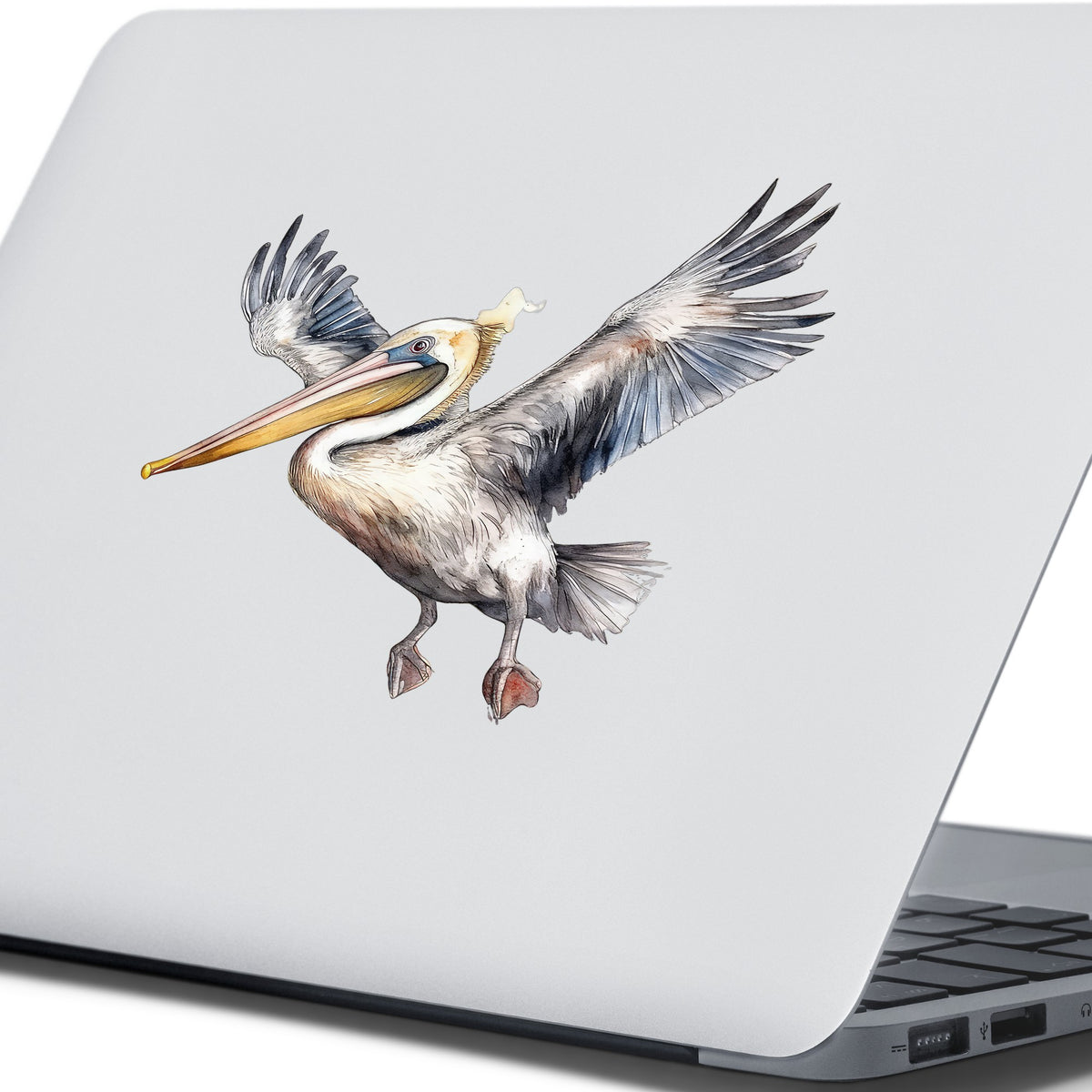 Pelican Taking Flight UV DTF sticker applied to a laptop