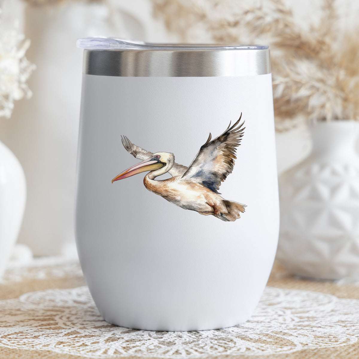 Coastal Pelican In Flight UV DTF sticker applied to a stemless wine glass