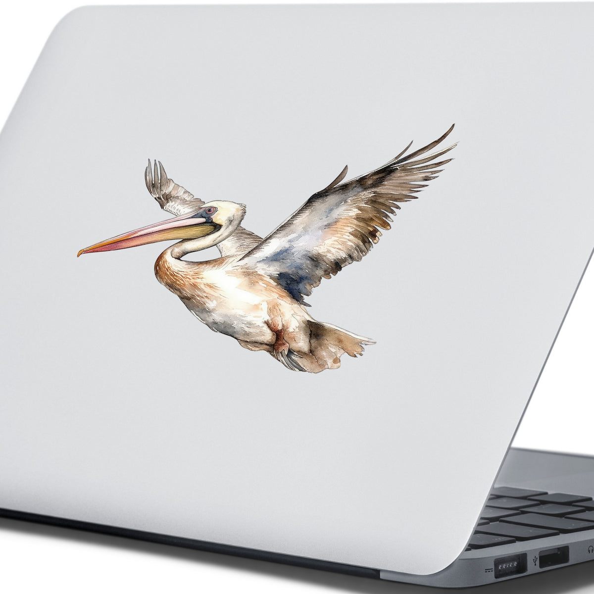 Coastal Pelican In Flight UV DTF sticker applied to a laptop