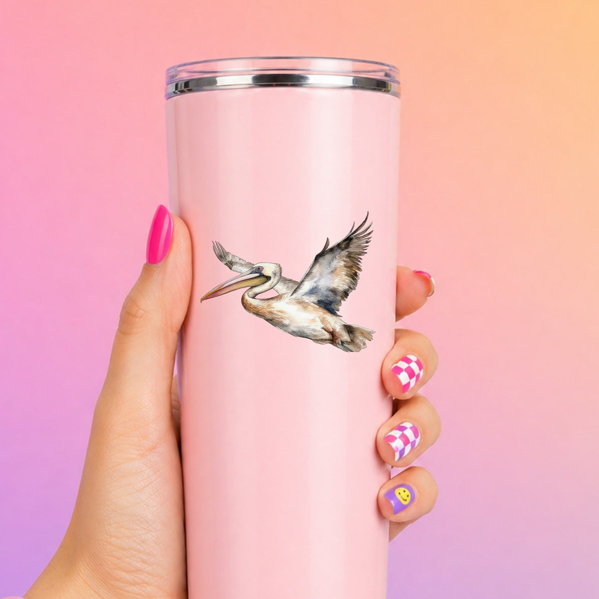 Coastal Pelican In Flight UV DTF sticker applied to a pink tumbler