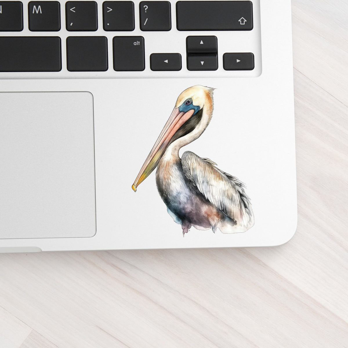 Standing Pelican UV DTF sticker applied to a laptop beside the keyboard