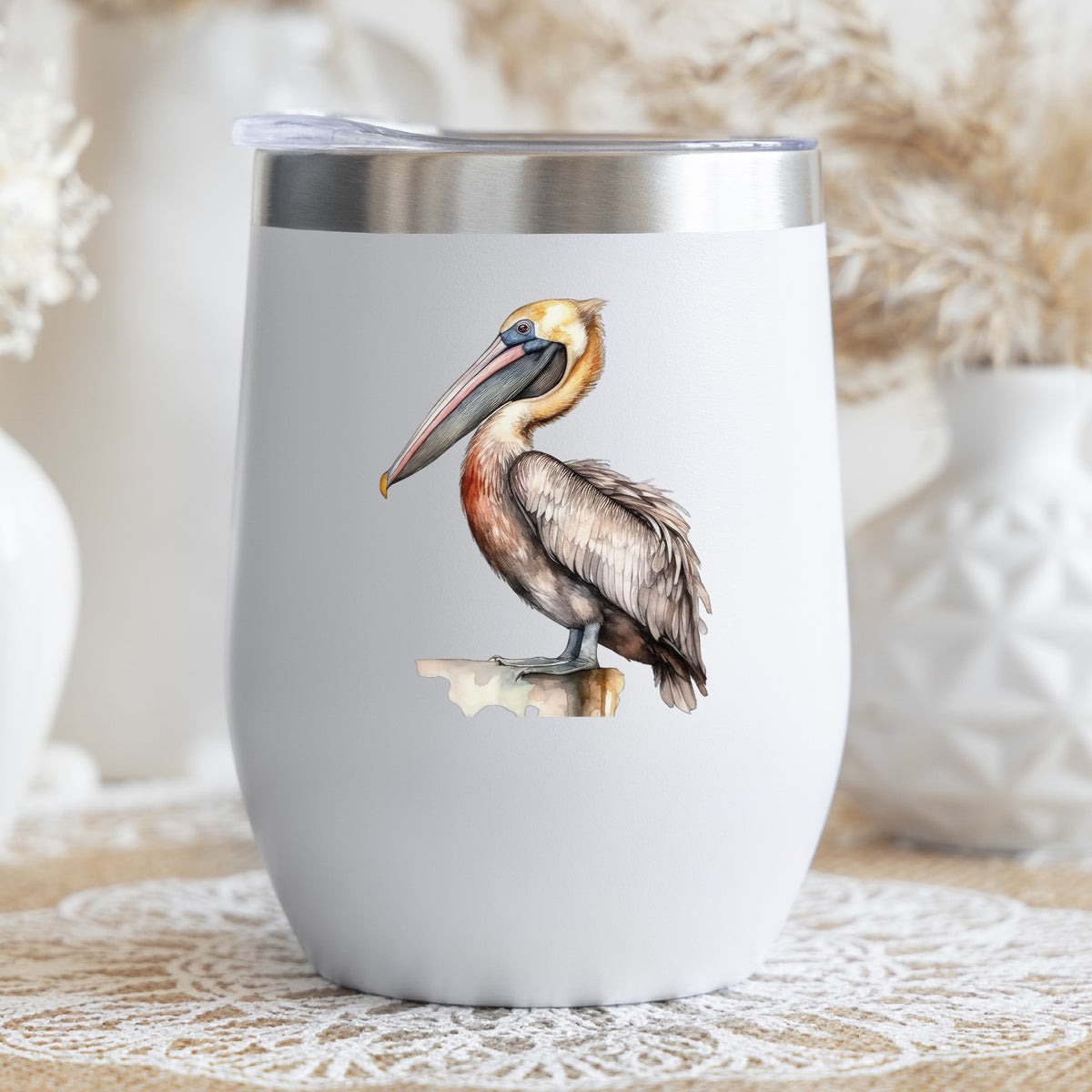 Golden Head Pelican UV DTF sticker applied to a stemless wine glass