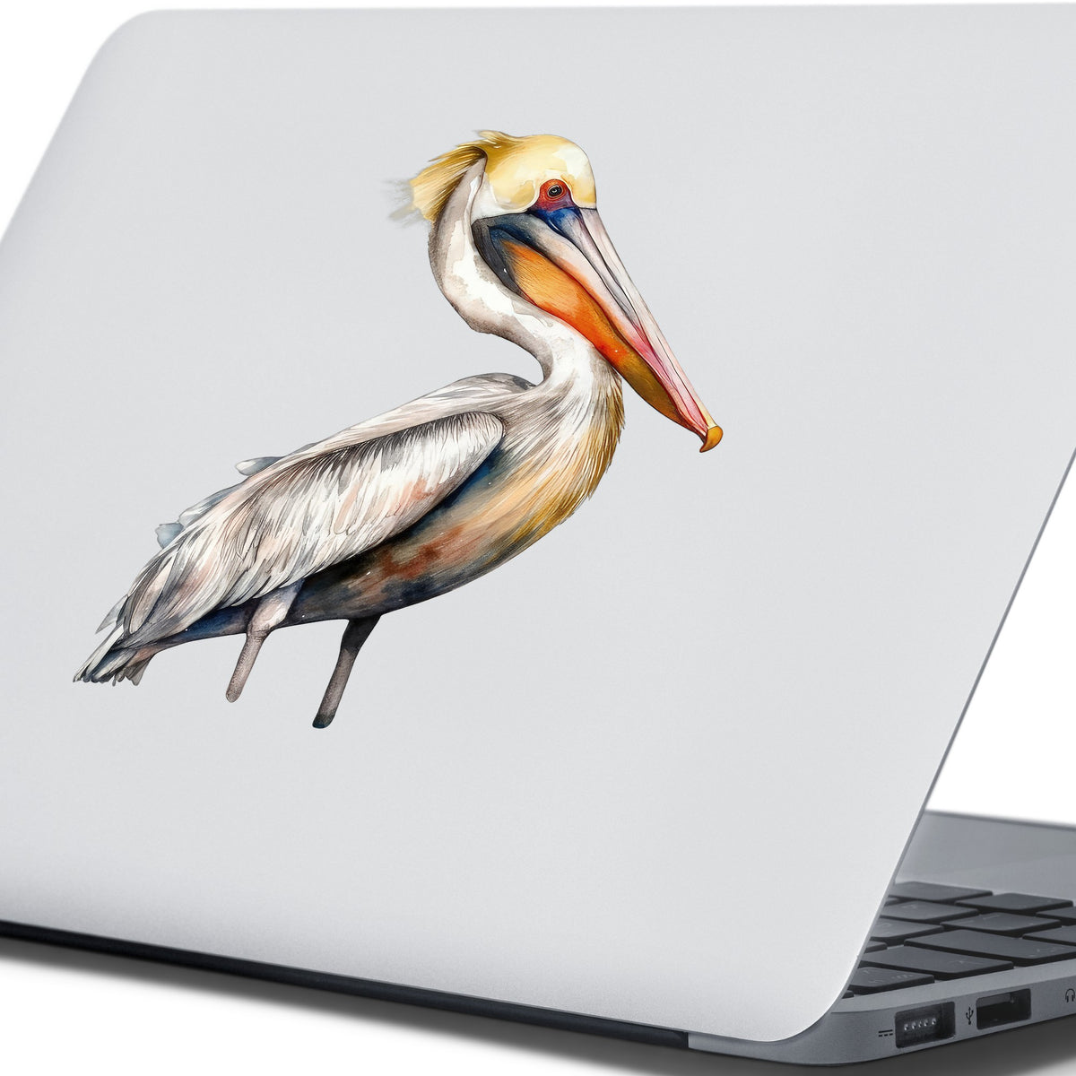 Yellow Crest Pelican UV DTF sticker applied to a laptop