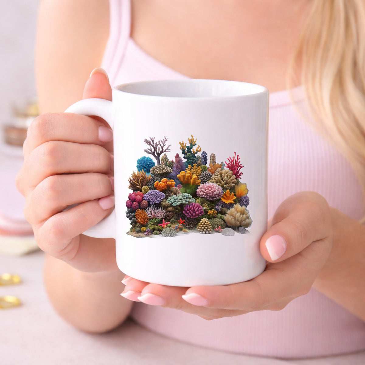 Colorful Coral Reef UV DTF sticker applied to a white coffee mug held in both hands