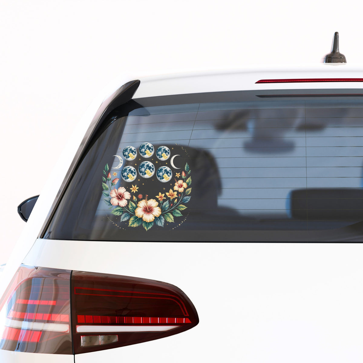 Moon Phases With Hibiscus Flowers UV DTF sticker applied to the rear window of a white car