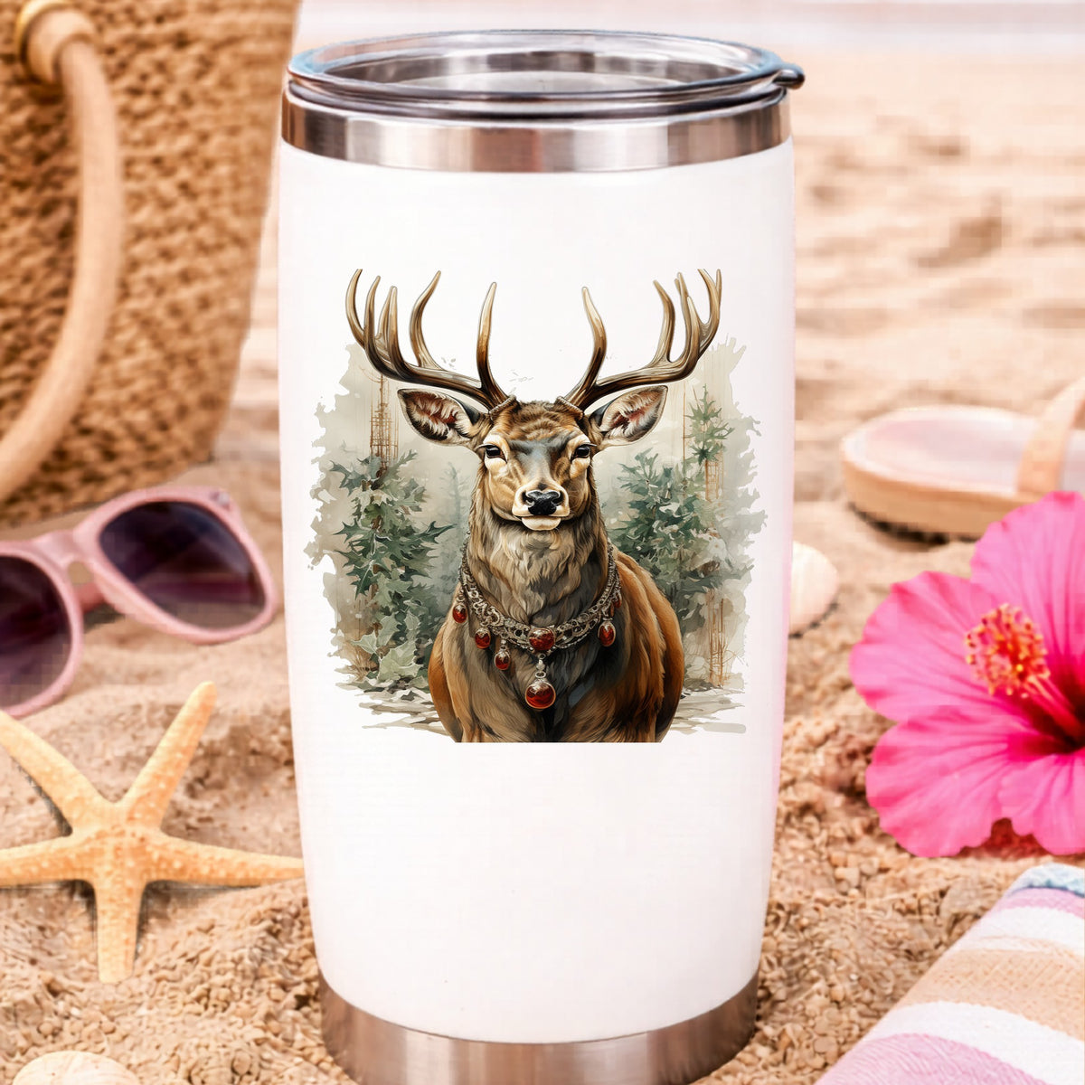 Stag With Jeweled Necklace UV DTF sticker applied to a white travel tumbler on beach sand