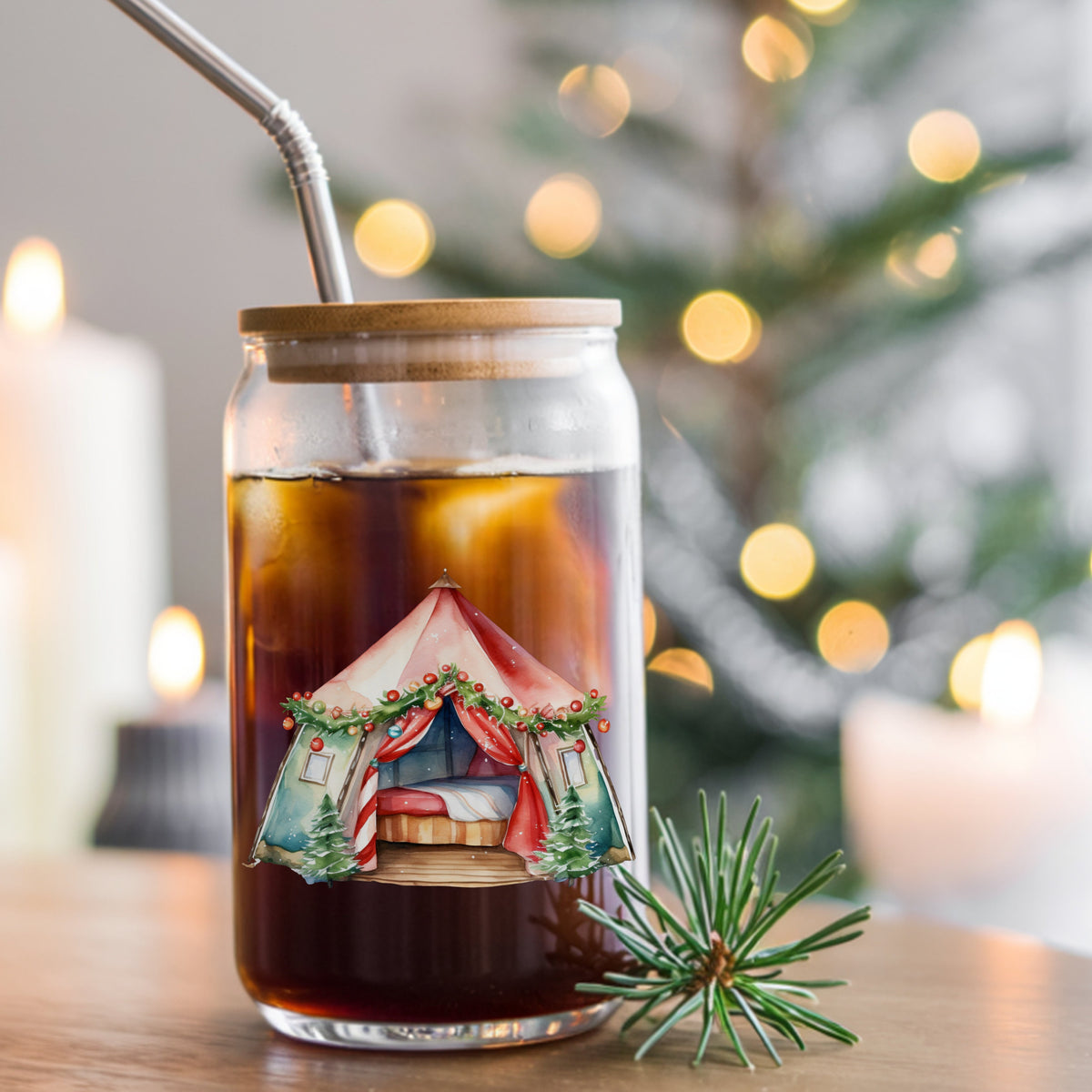 Christmas Glamping Tent UV DTF sticker applied to a glass can cup of iced coffee with a straw