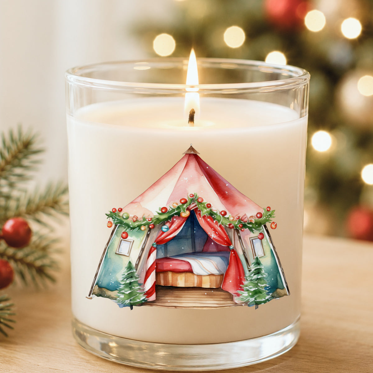 Christmas Glamping Tent UV DTF sticker applied to a white candle in a glass holder near Christmas lights