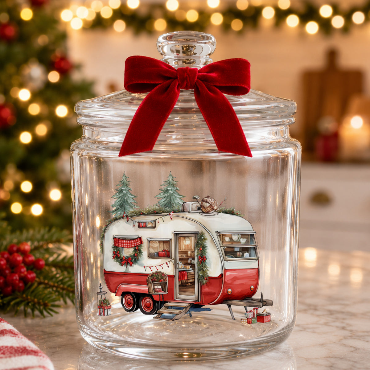 Vintage Christmas Camper Trailer UV DTF sticker applied to a glass candy jar tied with a red bow
