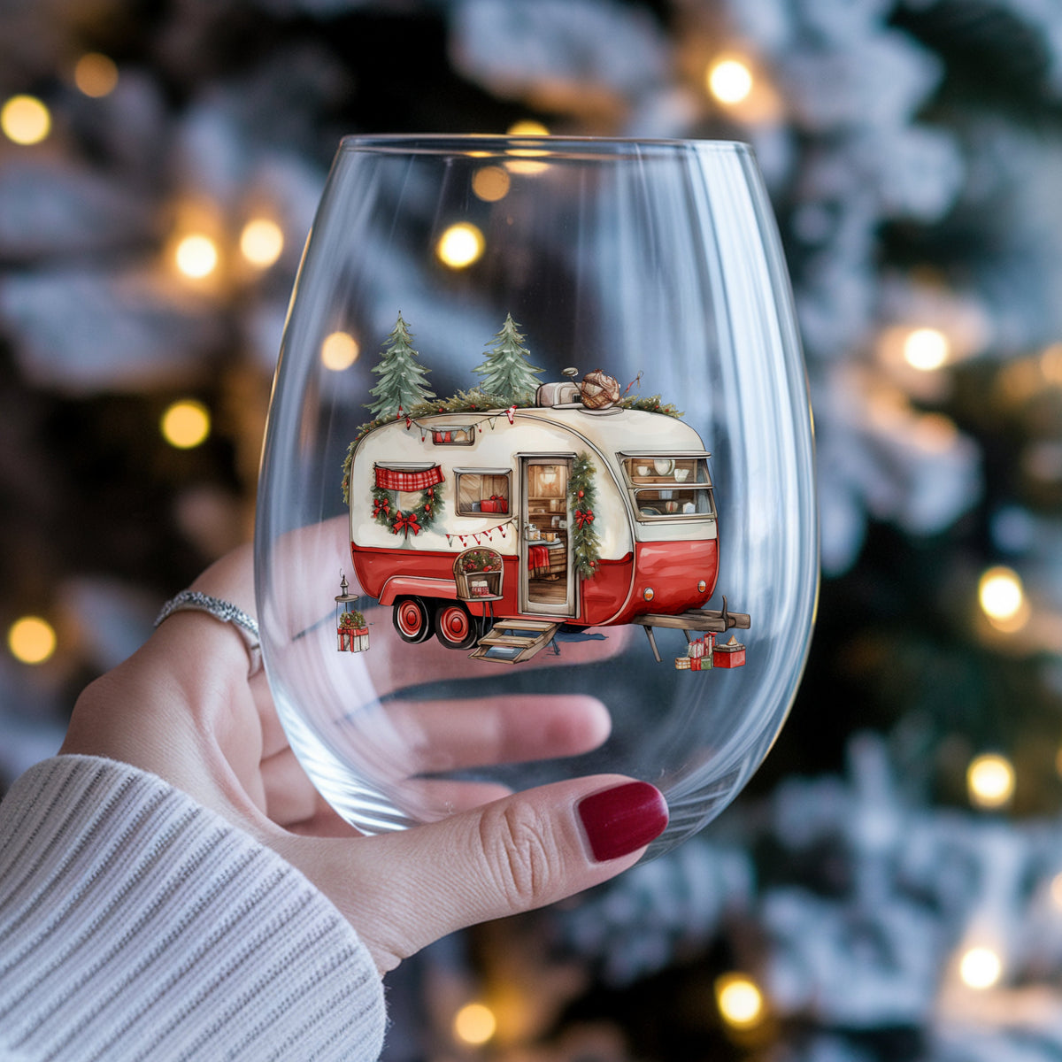 Vintage Christmas Camper Trailer UV DTF sticker applied to a stemless wine glass held in hand