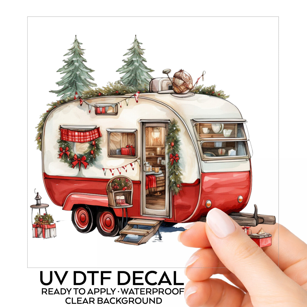 Vintage Christmas Camper Trailer UV DTF sticker on its backing card, held in hand