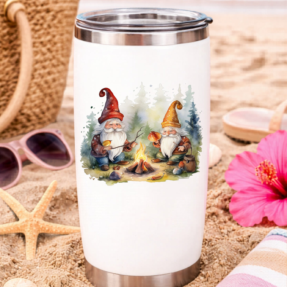Gnomes At A Campfire UV DTF sticker applied to a white travel tumbler on beach sand