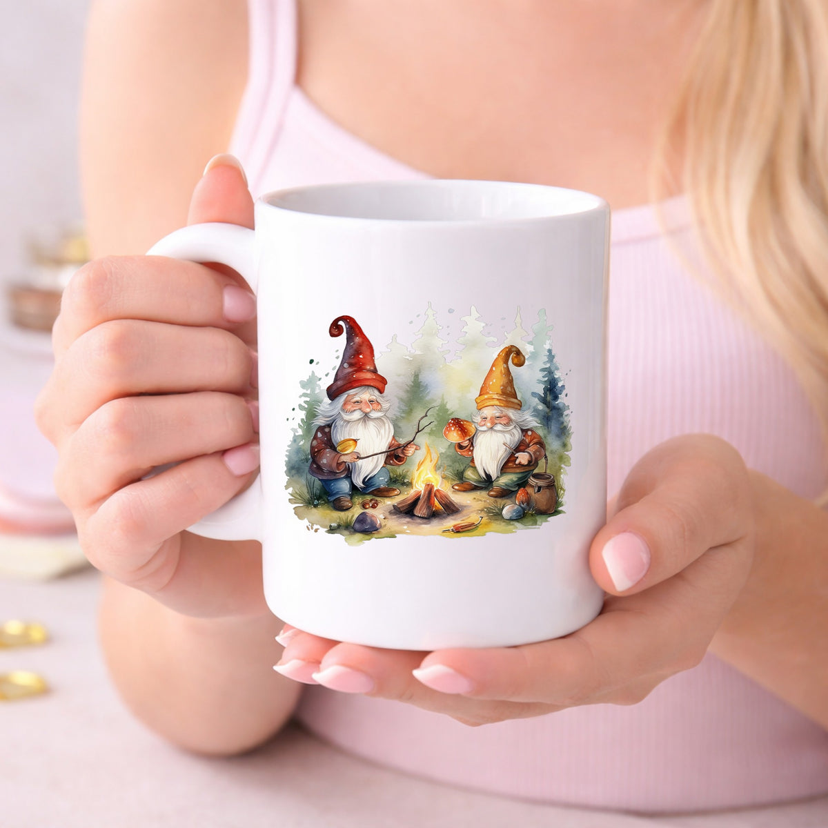 Gnomes At A Campfire UV DTF sticker applied to a white coffee mug held in both hands