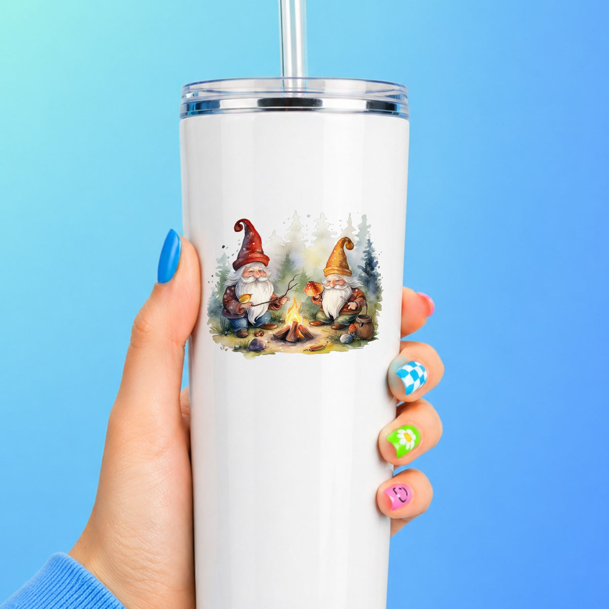 Gnomes At A Campfire UV DTF sticker applied to a white straw tumbler on a blue background