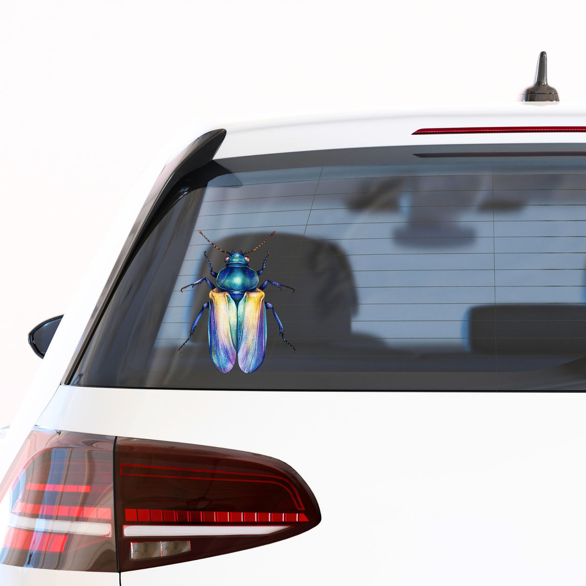 Gold And Blue Jewel Beetle UV DTF sticker applied to the rear window of a white car