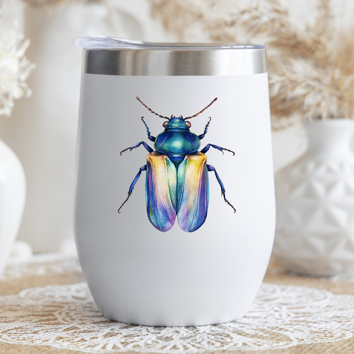 Gold And Blue Jewel Beetle UV DTF sticker applied to a white stemless tumbler with a lid