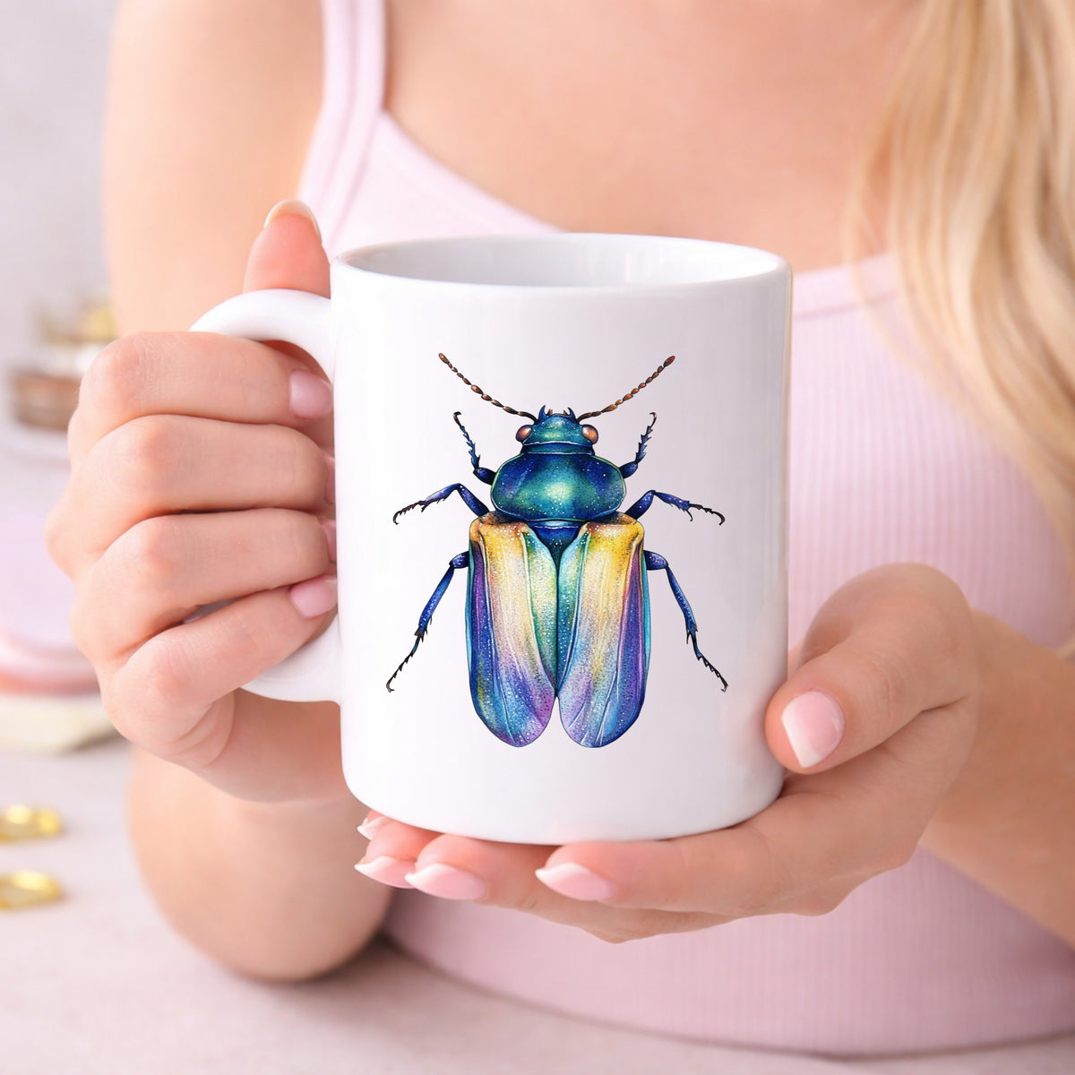 Gold And Blue Jewel Beetle UV DTF sticker applied to a white coffee mug held in both hands