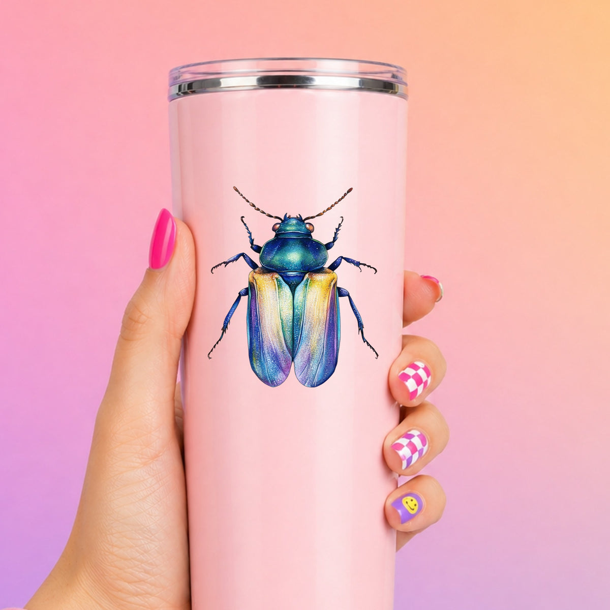 Gold And Blue Jewel Beetle UV DTF sticker applied to a tall pink tumbler on a pink and orange background
