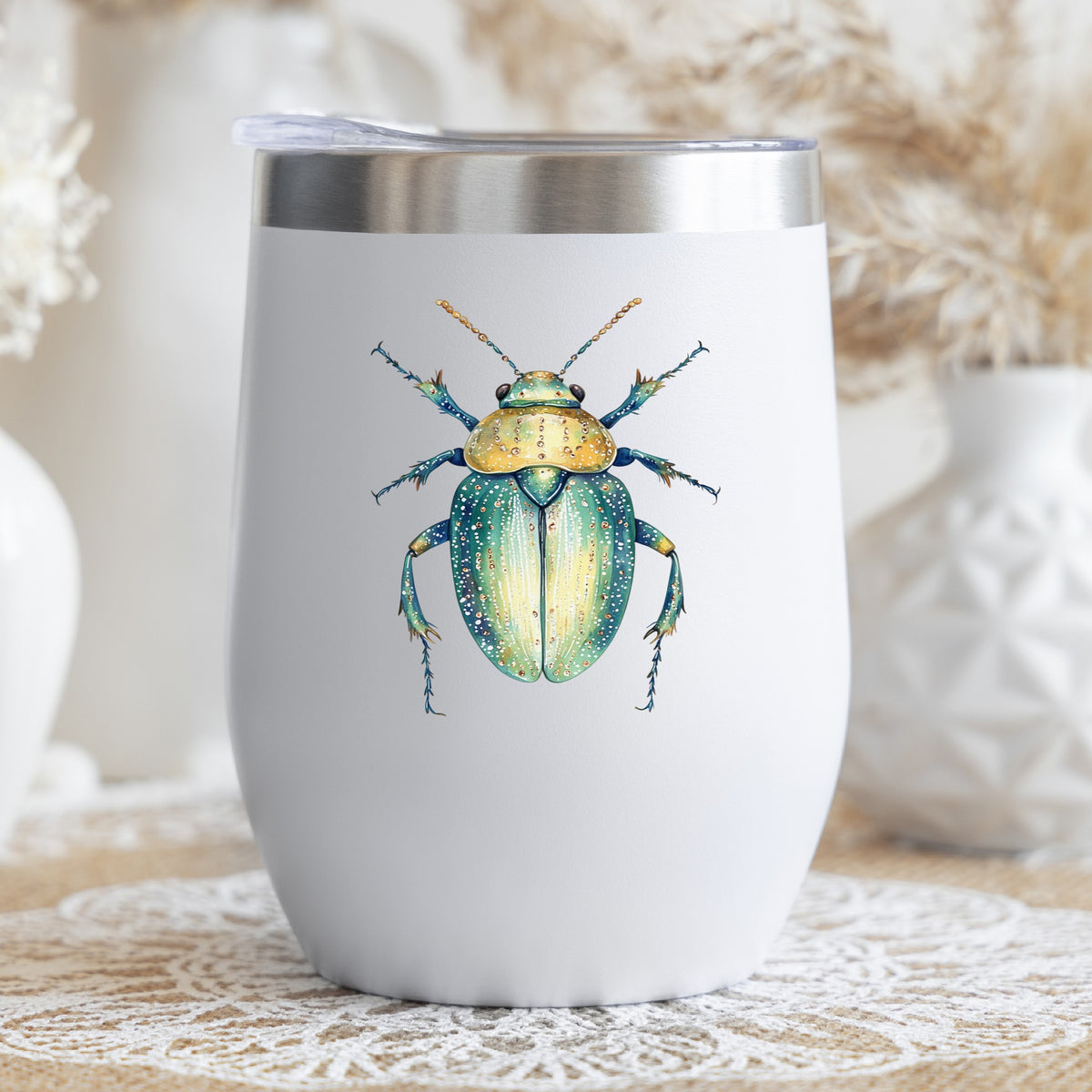White Dotted Teal Beetle UV DTF sticker applied to a white stemless tumbler with a lid