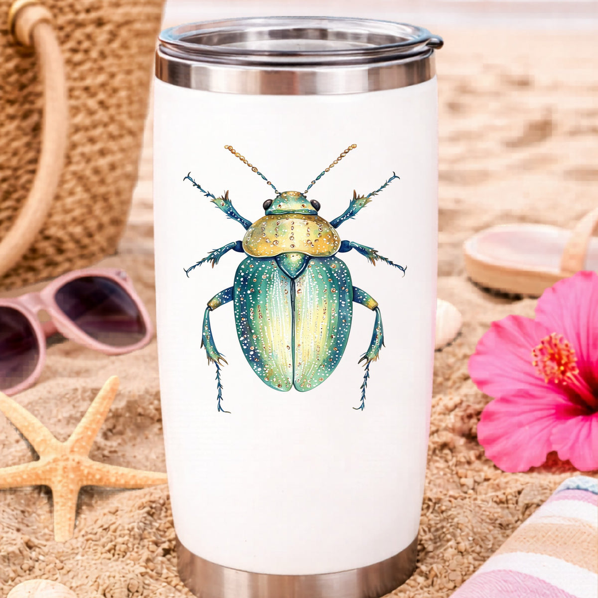 White Dotted Teal Beetle UV DTF sticker applied to a white travel tumbler on beach sand