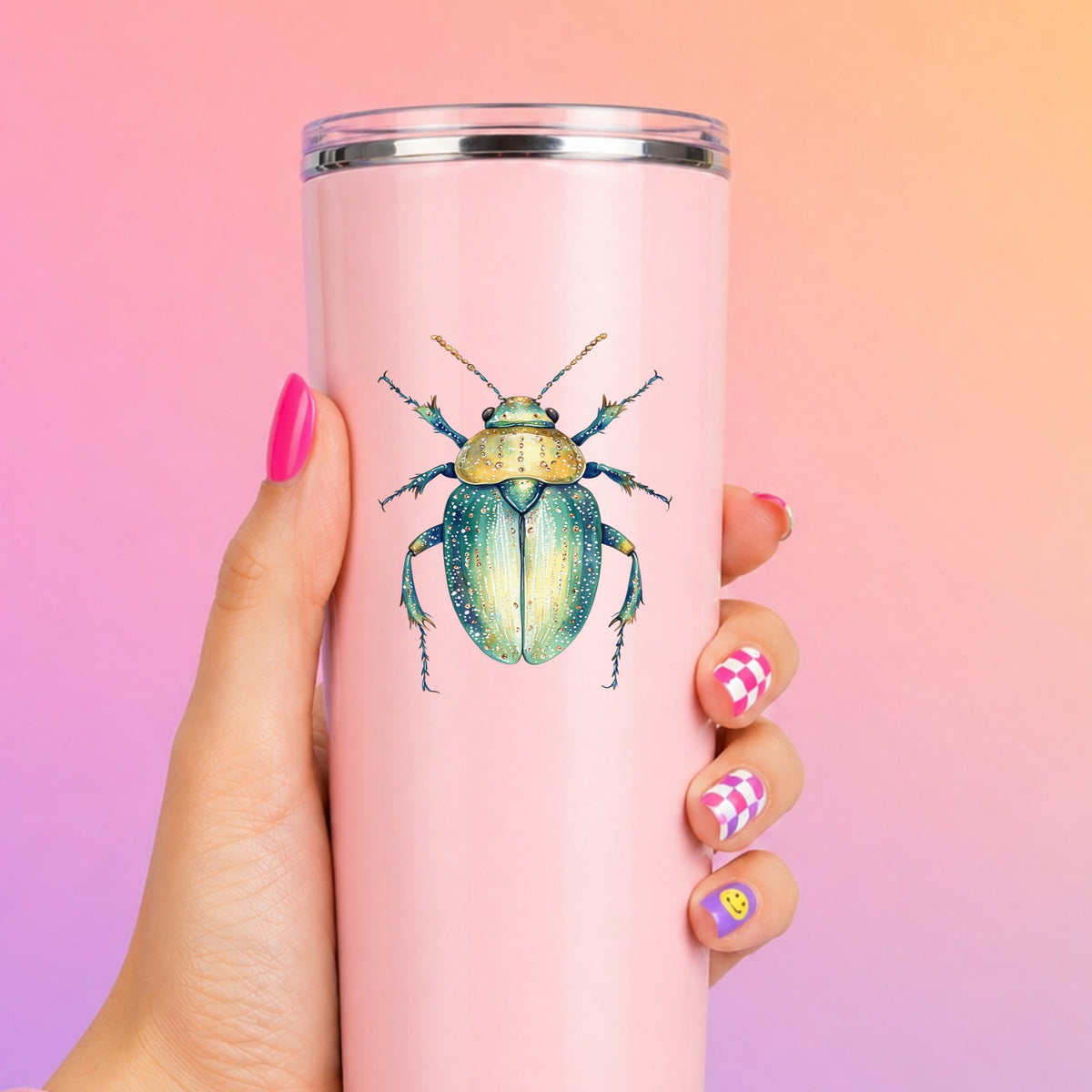 White Dotted Teal Beetle UV DTF sticker applied to a tall pink tumbler on a pink and orange background