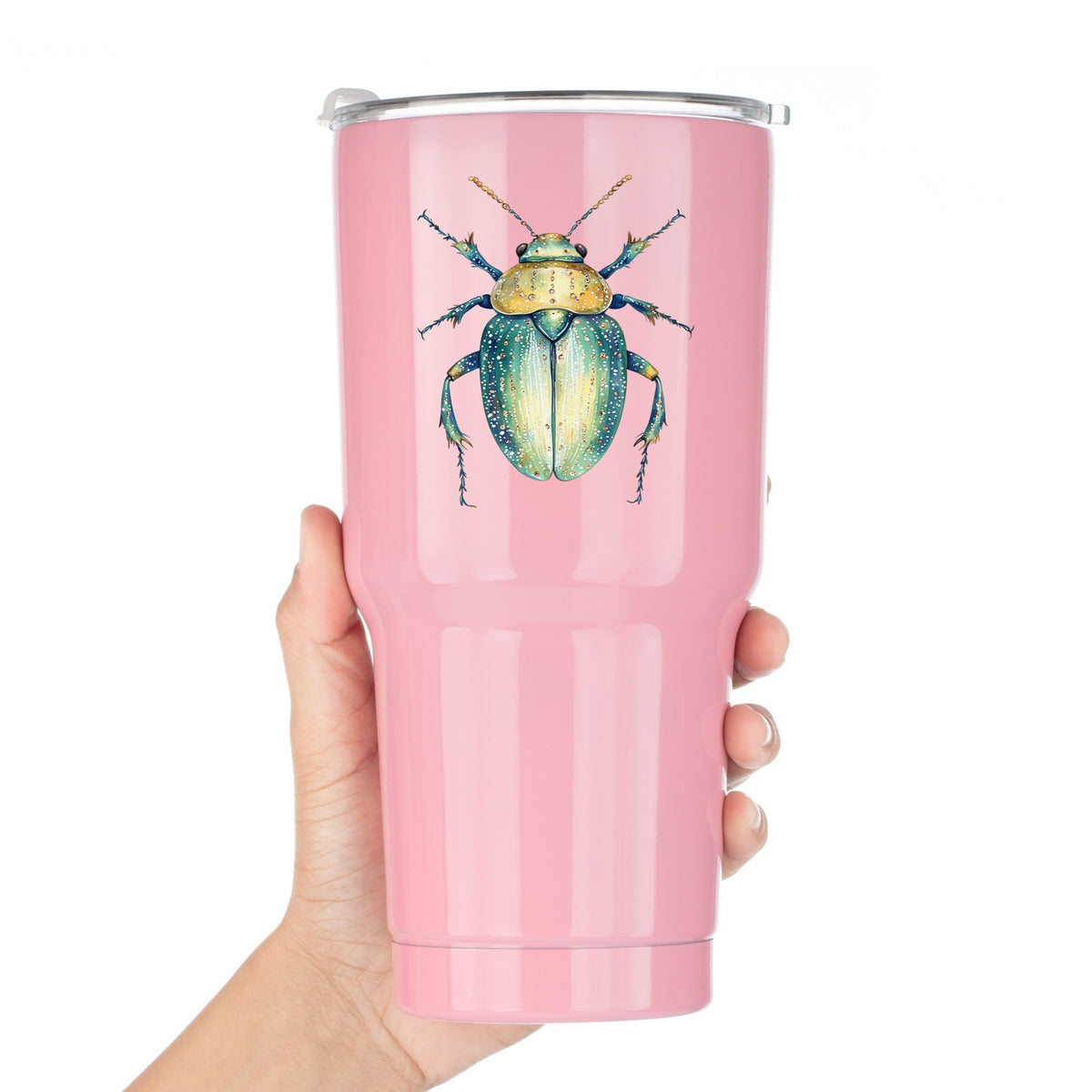 White Dotted Teal Beetle UV DTF sticker applied to a pink tumbler held against a white background