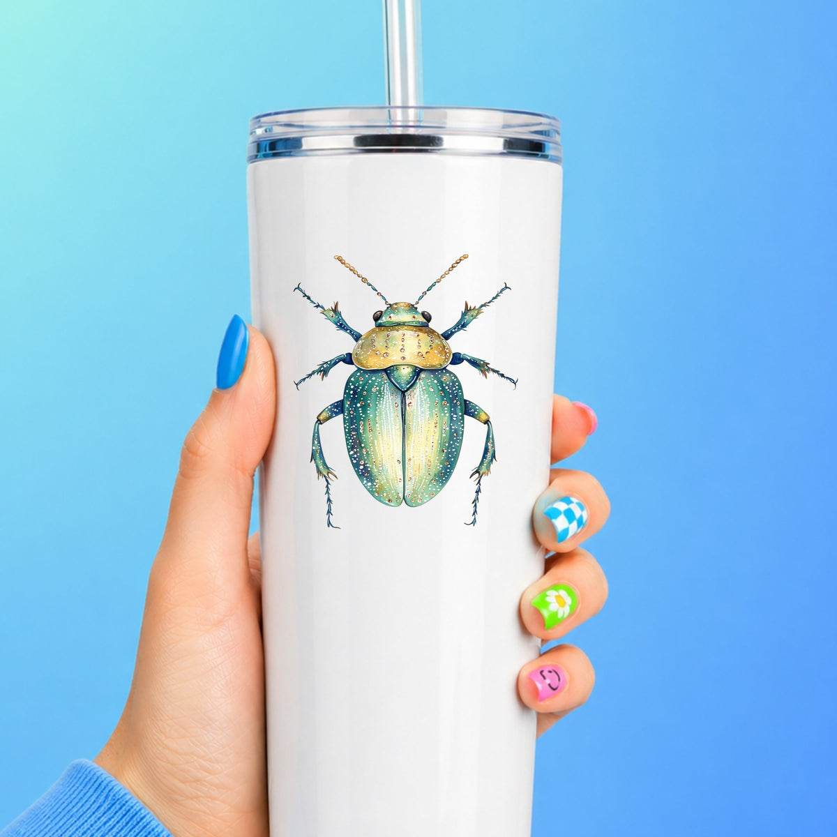 White Dotted Teal Beetle UV DTF sticker applied to a white straw tumbler on a blue background