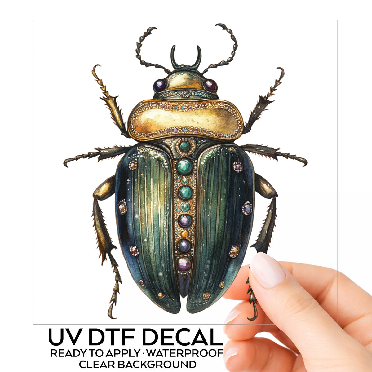 Jeweled Gold Scarab Beetle UV DTF sticker on its backing card, held in hand