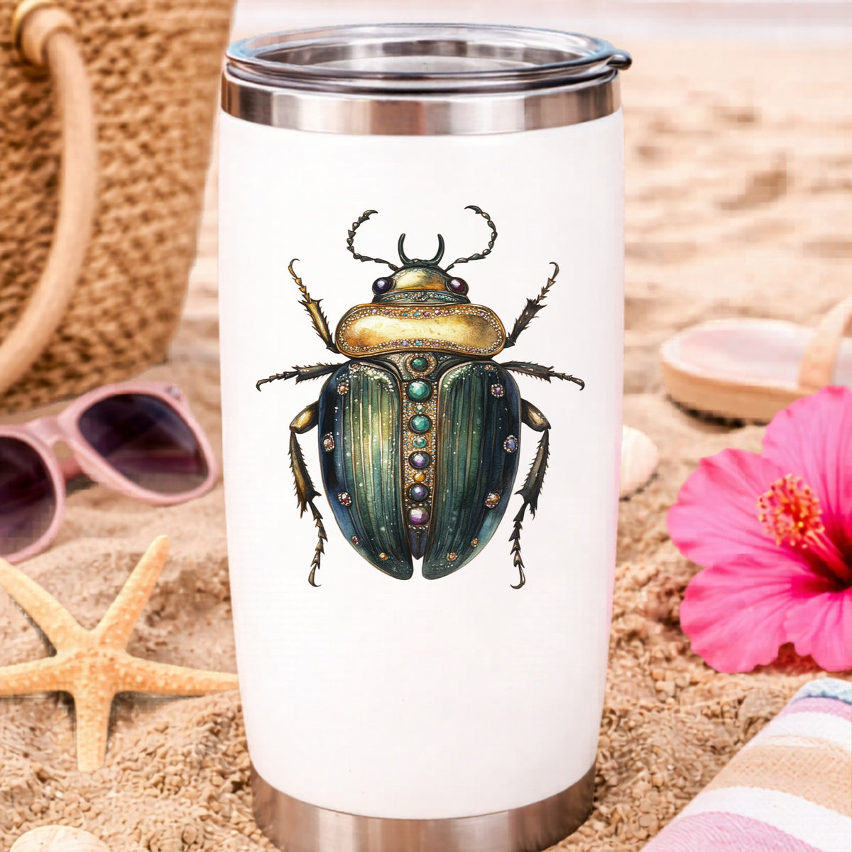 Jeweled Gold Scarab Beetle UV DTF sticker applied to a white travel tumbler on beach sand