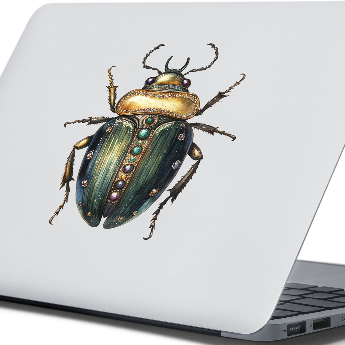 Jeweled Gold Scarab Beetle UV DTF sticker applied to the lid of a silver laptop