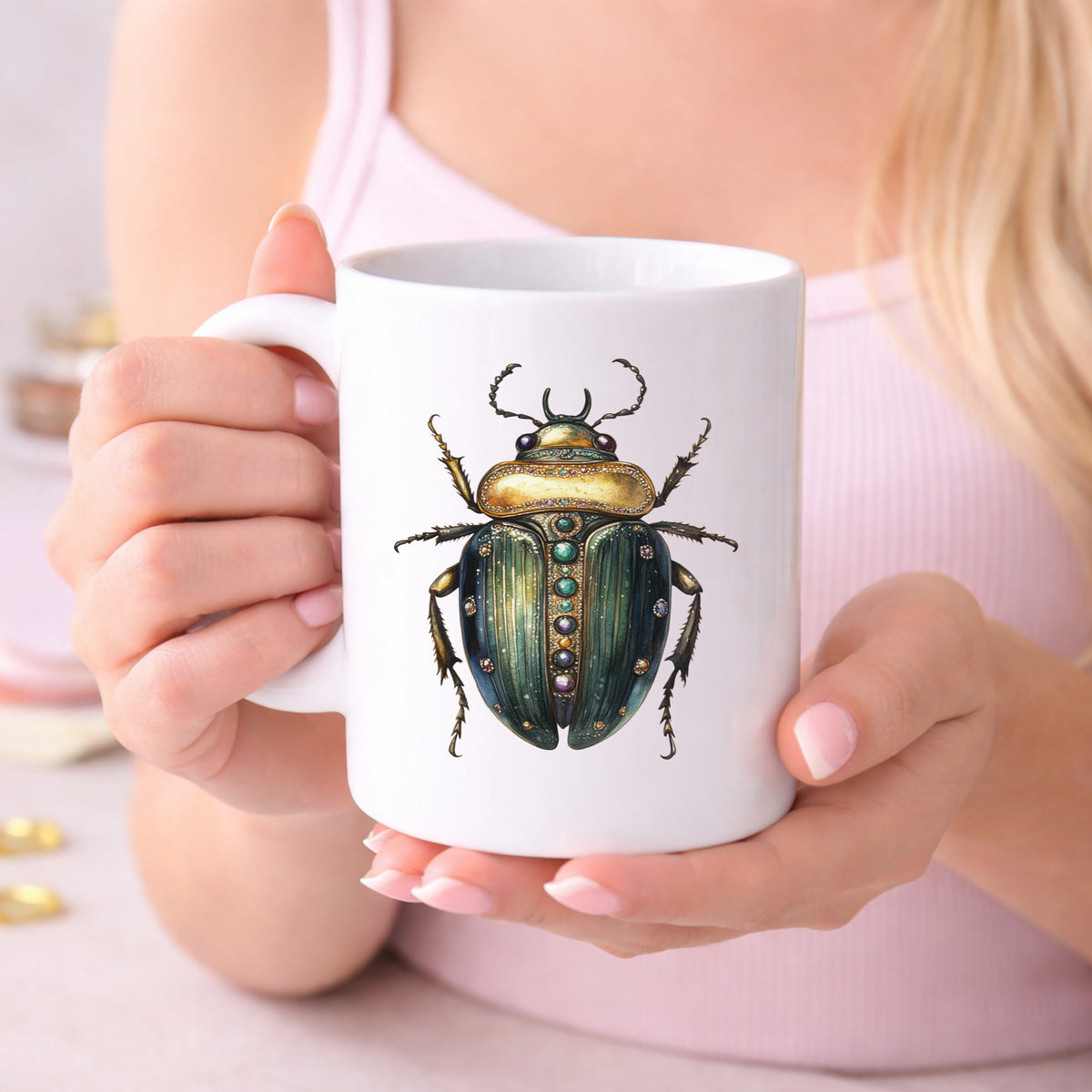 Jeweled Gold Scarab Beetle UV DTF sticker applied to a white coffee mug held in both hands
