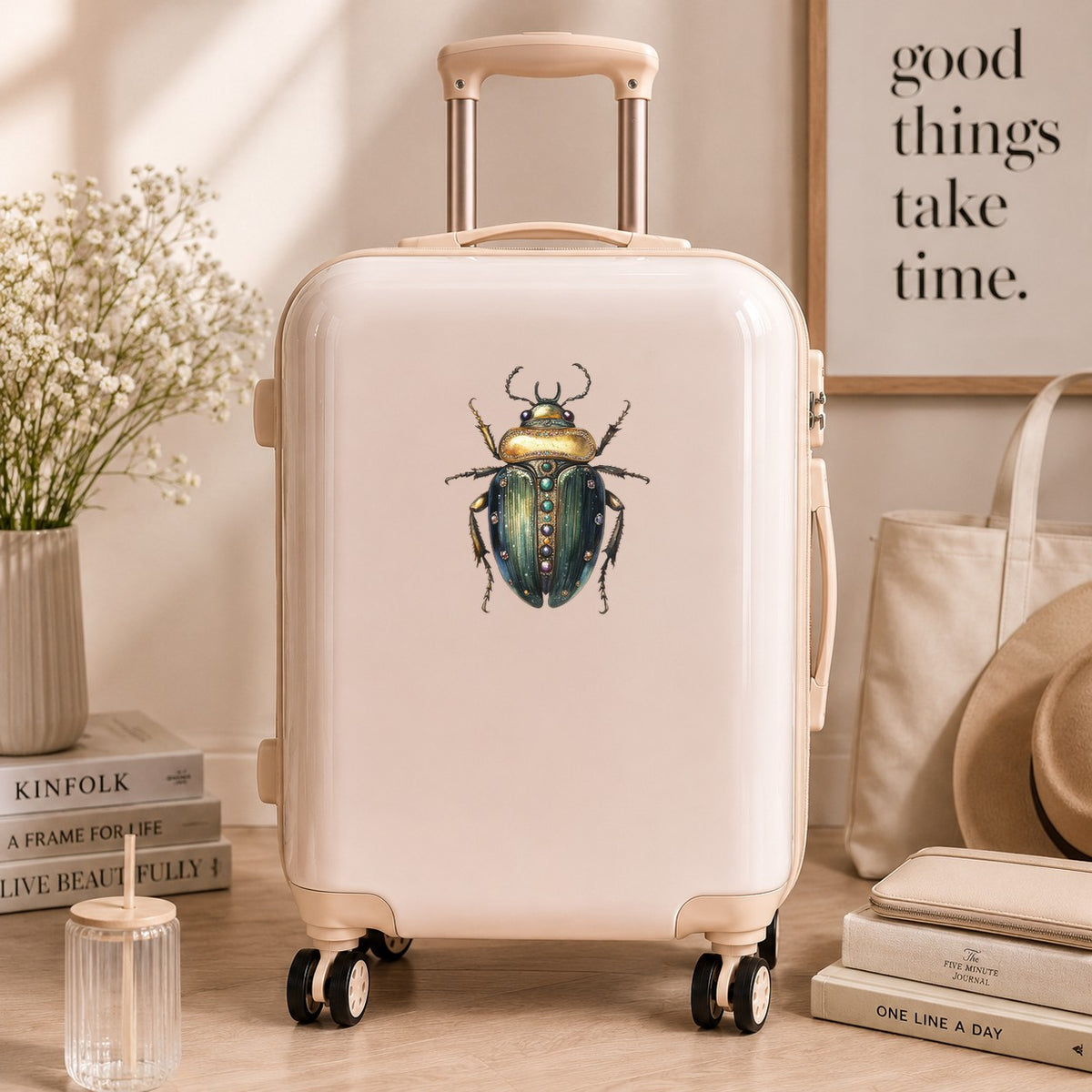 Jeweled Gold Scarab Beetle UV DTF sticker applied to a cream carry-on suitcase