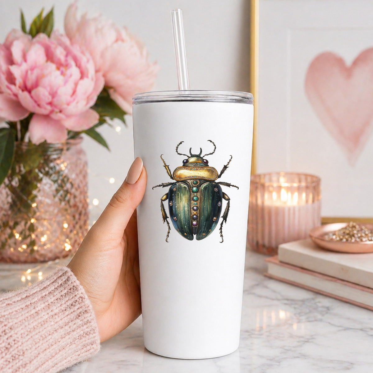 Jeweled Gold Scarab Beetle UV DTF sticker applied to a white straw tumbler beside pink peonies