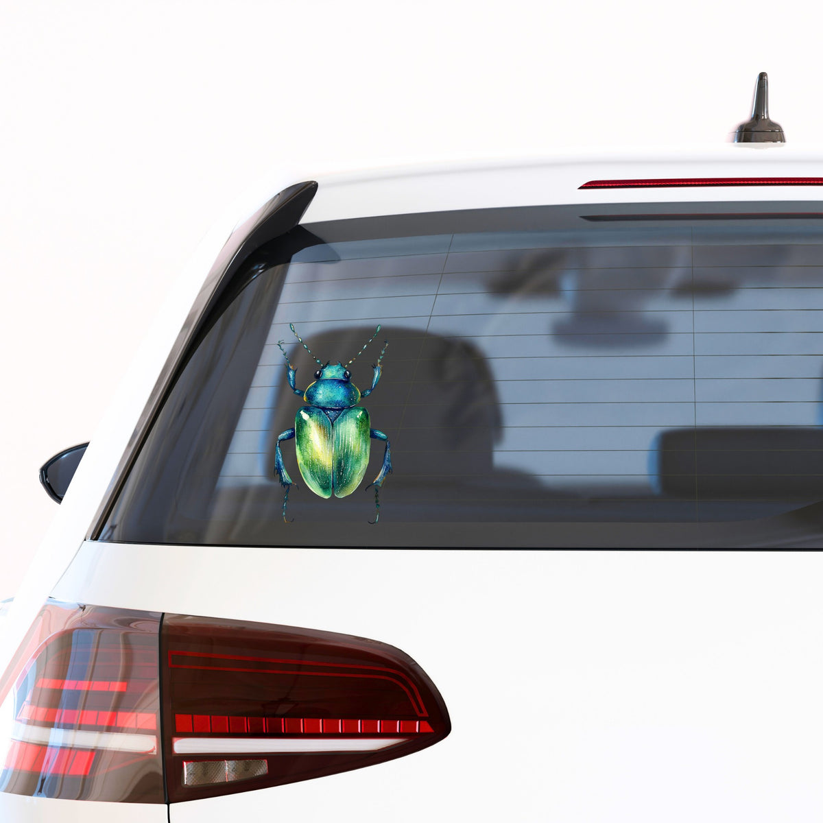 Emerald Green Beetle UV DTF sticker applied to the rear window of a white car