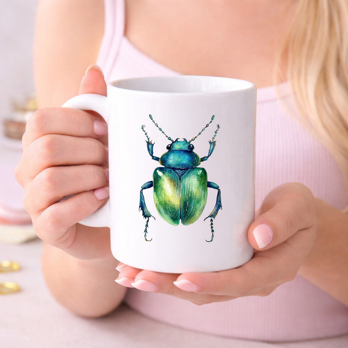 Emerald Green Beetle UV DTF sticker applied to a white coffee mug held in both hands