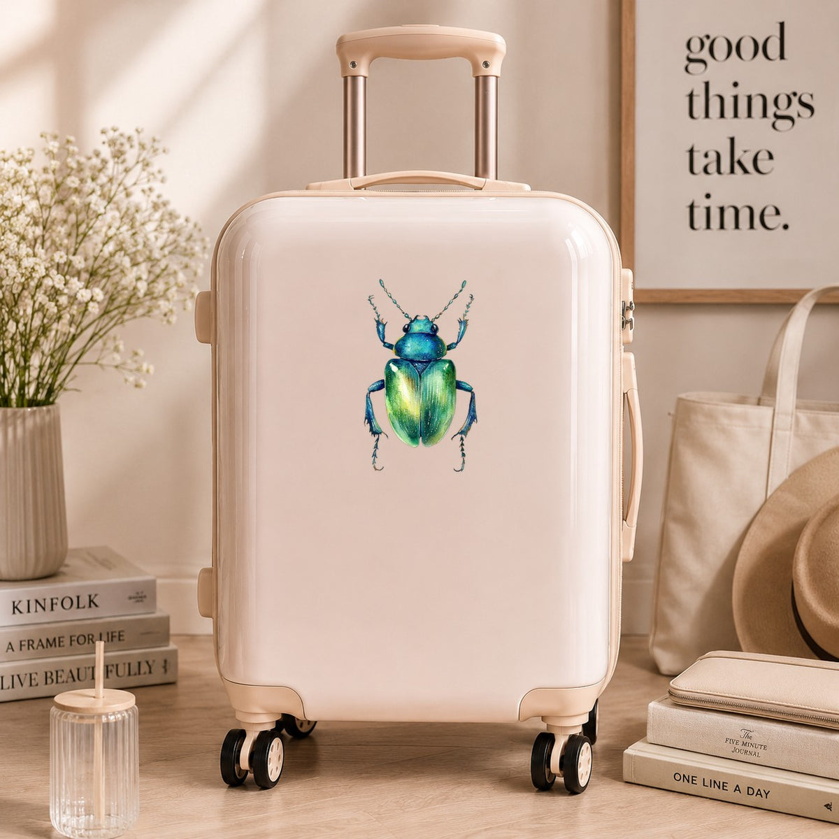 Emerald Green Beetle UV DTF sticker applied to a cream carry-on suitcase