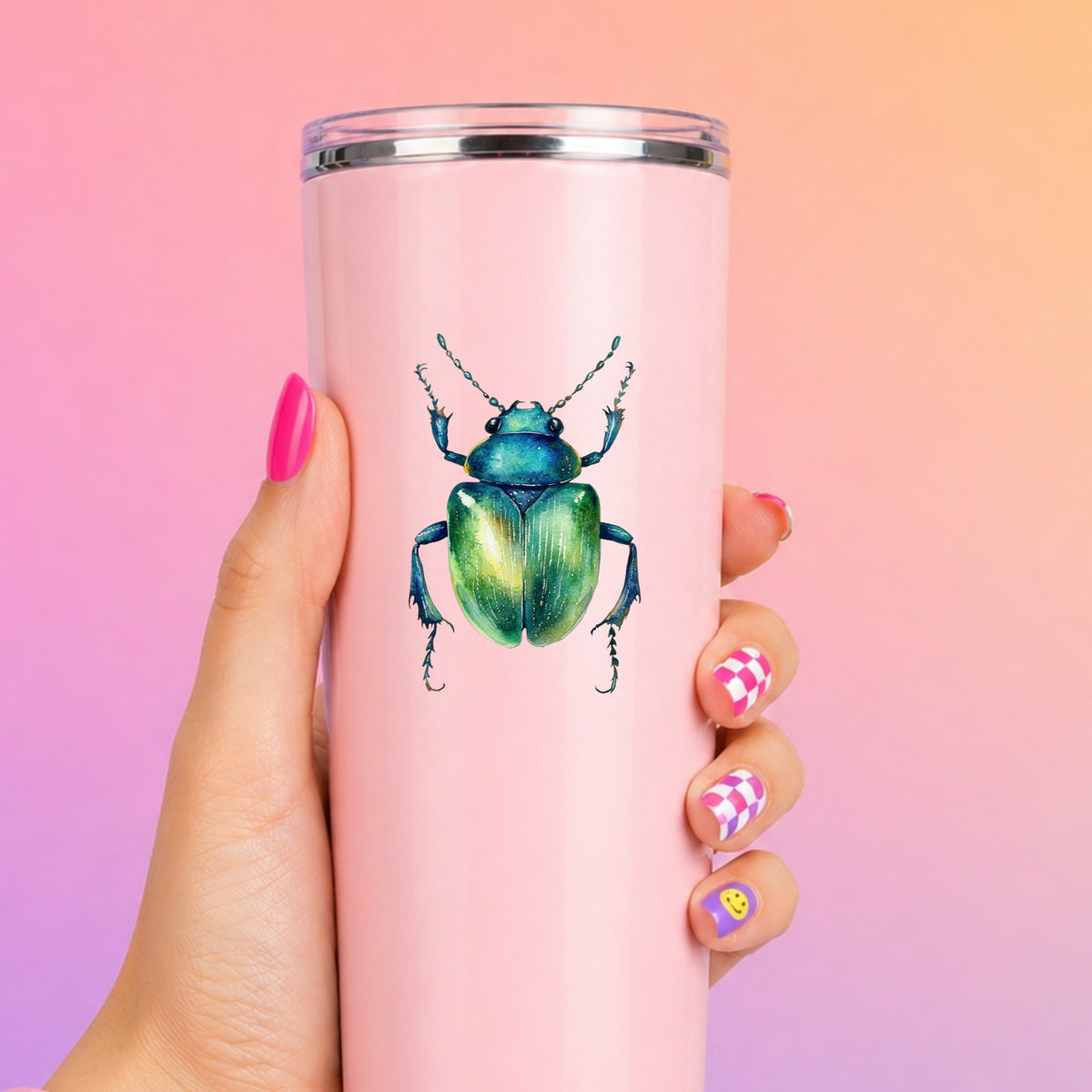 Emerald Green Beetle UV DTF sticker applied to a tall pink tumbler on a pink and orange background