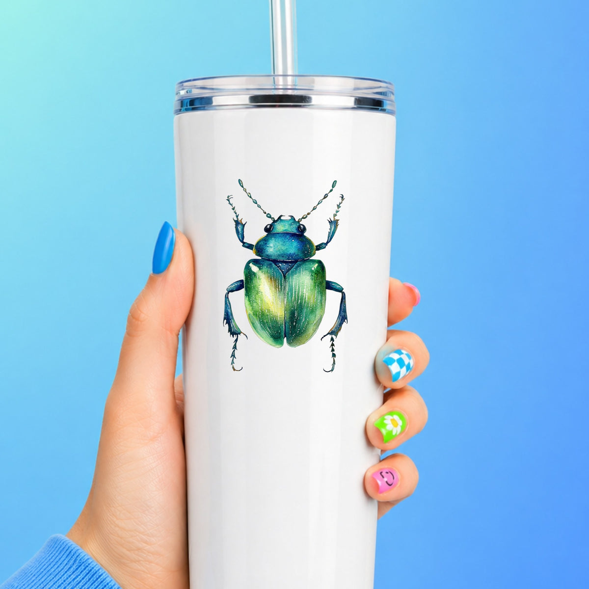 Emerald Green Beetle UV DTF sticker applied to a white straw tumbler on a blue background